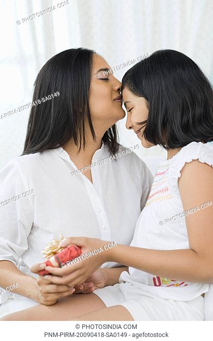 Girl giving a present to her mother