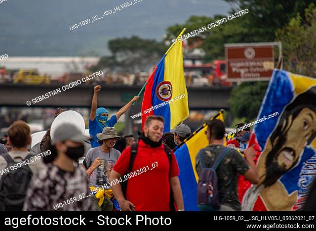 People with Colombia's national flags participate in a demonstration in tribute and memory of Lucas Villa, young man killed during Anti-government...