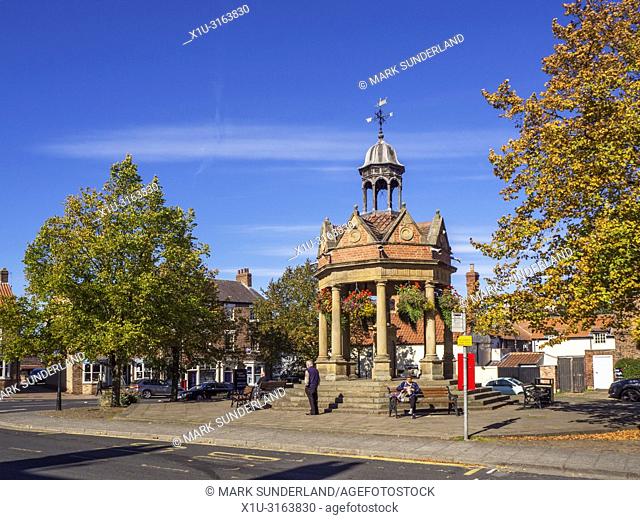 The Fountain former water pump in St James Square in early autumn at Boroughbridge North Yorkshire England