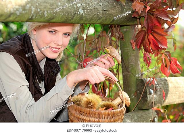 Woman with basket of chestnuts and mushrooms