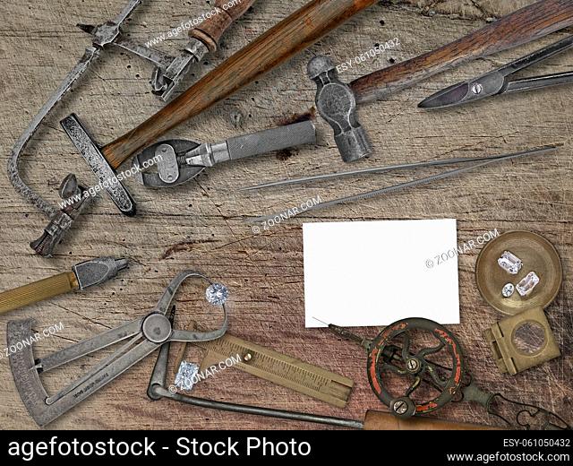 vintage jeweler tools and diamonds over wooden bench, space for your business name