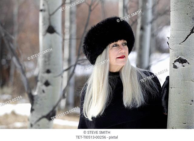 Woman with ushanka in forest