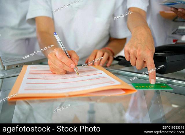 Women completing a worksheet with care carte vitale