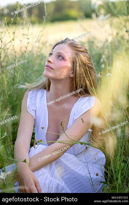 Young woman day dreaming in agricultural field