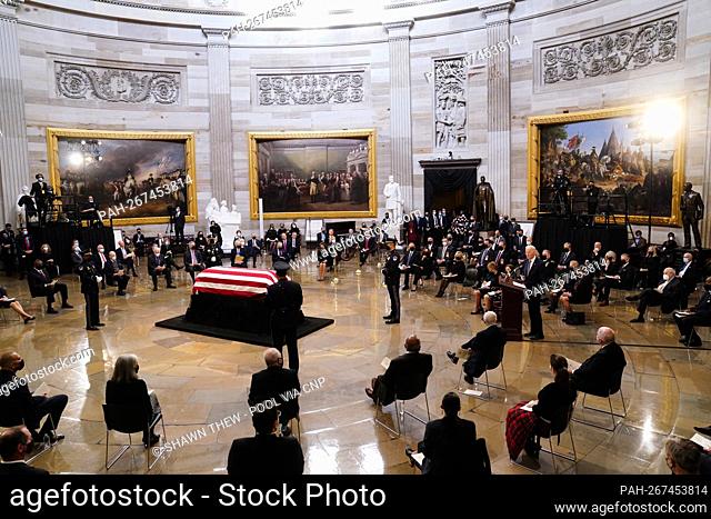 US President Joe Biden (R) speaks near the casket of former Republican Senator from Kansas Robert J. Dole during a ceremony preceding the lying in state in the...