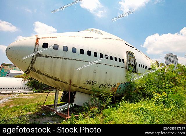Remains of a wrecked and graffitied Boeing 747 and two McDonnell Douglas MD-80s in a field in Bangkok, Thailand never to be flown again