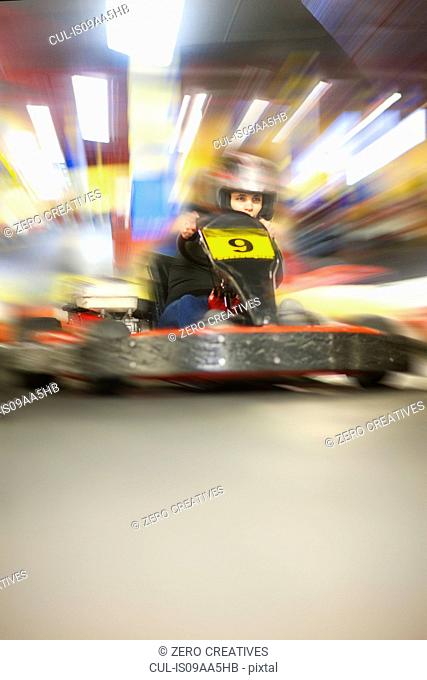 Young woman racing in go cart