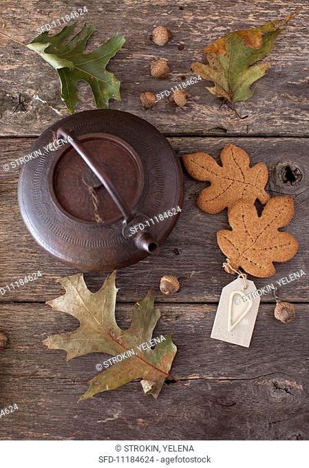 Whole Wheat Maple Graham Leaf Cookies with a Tea Kettle on a Wooden Table; Leaves and Acorns