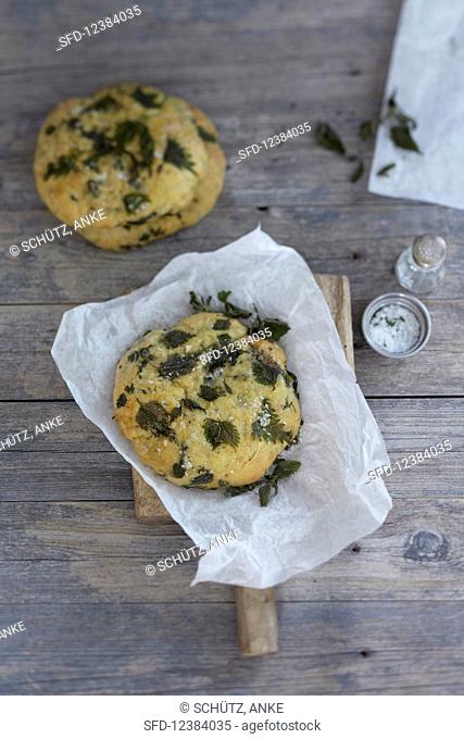 A stinging nettle bread roll on greaseproof paper
