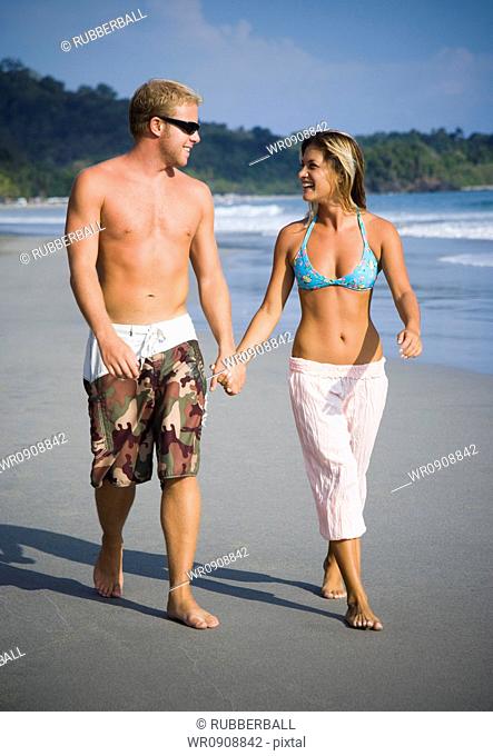 Romantic couple strolling on the beach