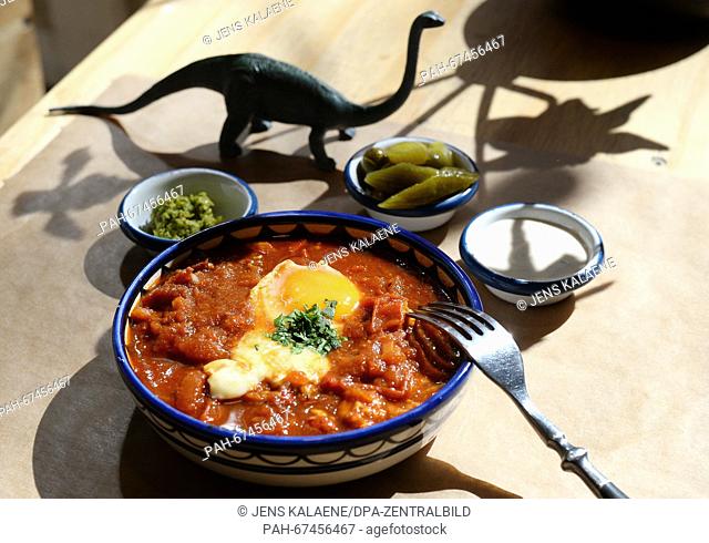 Shakshuka, a traditional Israeli egg dish, sits on a table with sides at Cafe Gordon in the district of Neukoelln in Berlin,  Germany, 01 April 2016