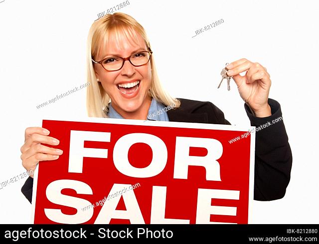 Attractive blonde holding keys & for sale sign isolated on a white background