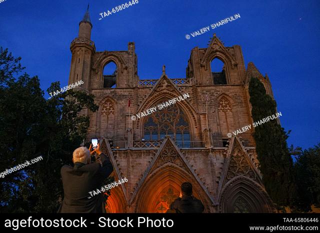 CYPRUS, FAMAGUSTA - DECEMBER 15, 2023: A view of the Lala Mustafa Pasha Mosque (the Cathedral of Saint Nicholas) at dusk