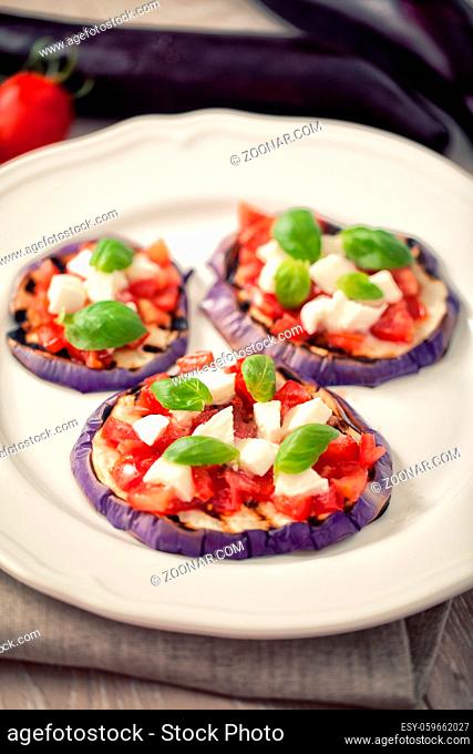 Baked eggplant with parmesan cheese, tomatoes and basil. High quality photo