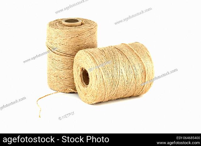 Pair of natural brown twisted jute twine spools isolated on white background
