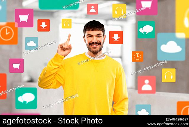 young man showing one finger in yellow sweatshirt