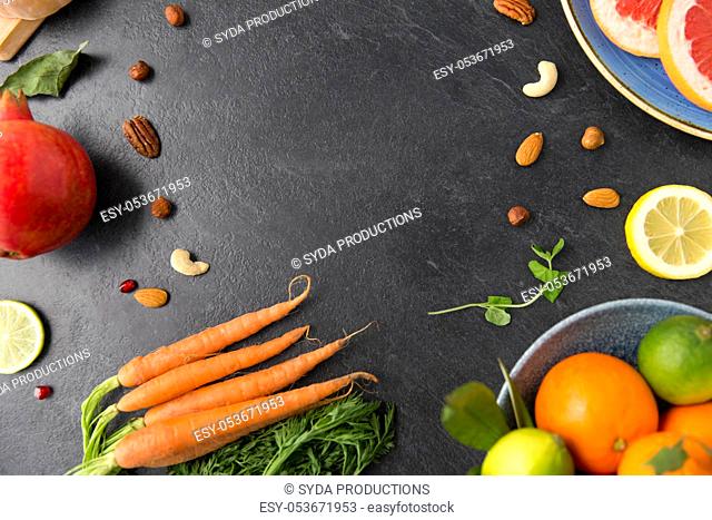 different vegetables and fruits on on slate table