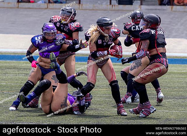 MEXICO CITY, MEXICO - JULY 11: A player of IXUS rushing avoid a tackle during the match between IXUS- Lingerie Football Team and NYX - Lingerie Football Team of...