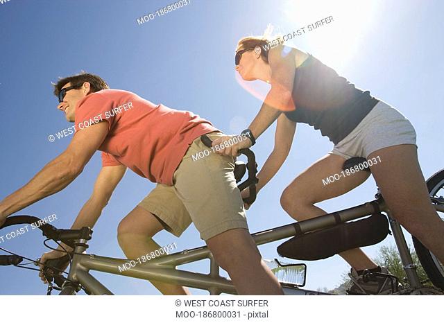 Mature couple on tandem bicycle