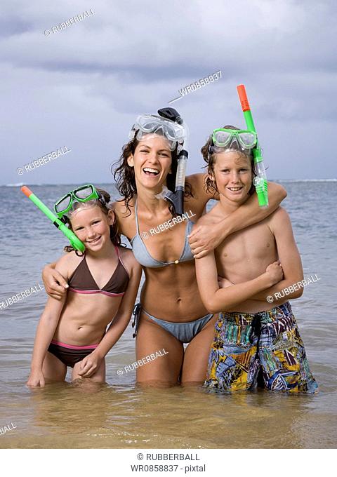 Portrait of a mother and her children wearing snorkel gear
