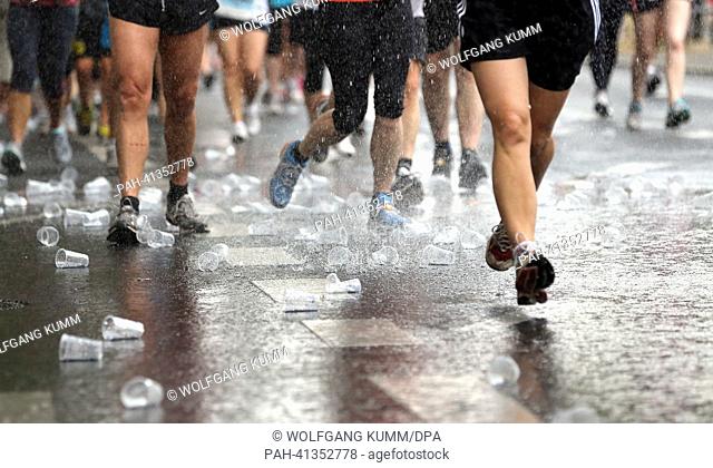 Participants of the 22nd Vattenfall City-Night refresh themselves by running underneath water sprayed on the street with a hose during the five kilometre long...