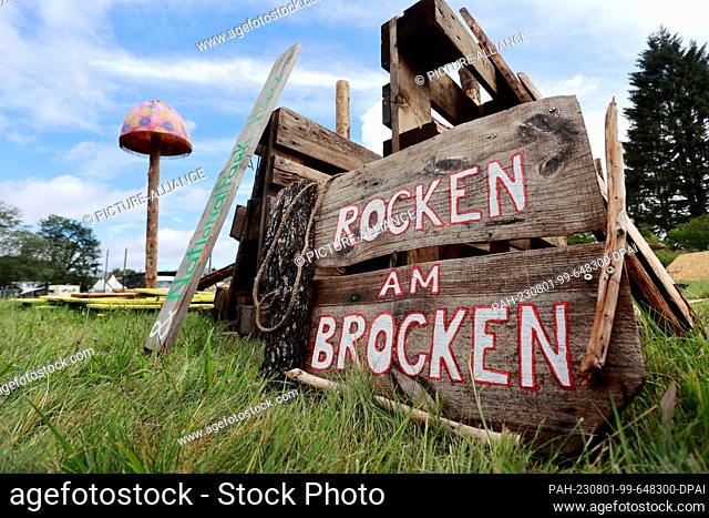 01 August 2023, Saxony-Anhalt, Elend: Signs for ""Rocken am Brocken"" lie on a festival meadow in Elend . For the festival ""Rocken am Brocken"" , from 3