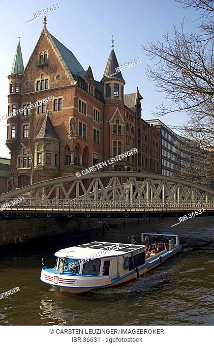 Trip boat cruising through the channels of the Hamburger Speicherstadt Germany