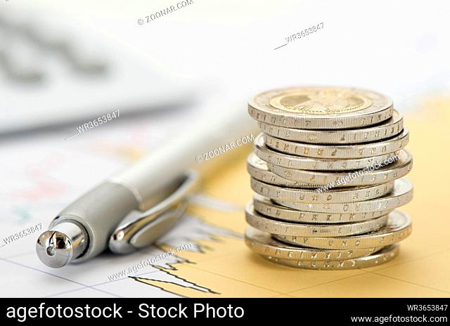 finance with stack of euro coins and calculator