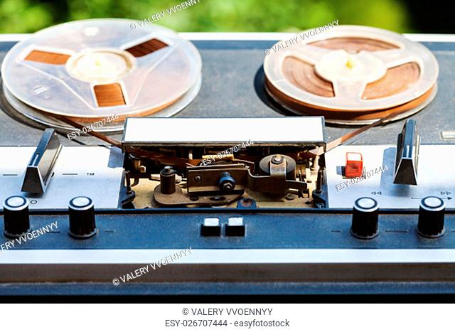 vintage reel-to-reel recorder with in reels outdoors