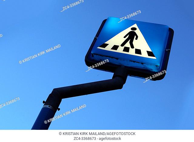 Blue and white crosswalk sign tilted view