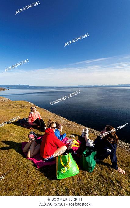 A family outing turns to laughter while having lunch along the cliffs of Helliwell on Hornby Island. Hornby Island, Northern Gulf Island's, British Columbia