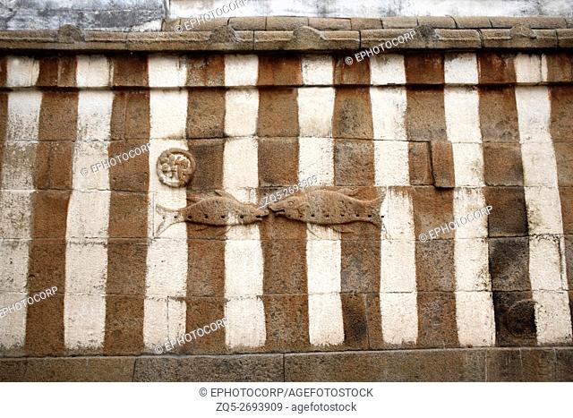 Carved figures of fish on the courtyard wall of Gomateshwara temple, Vindhyagiri Hill, Shravanbelgola, Karnataka, India
