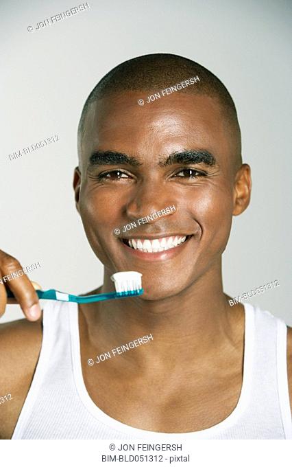 African man brushing teeth