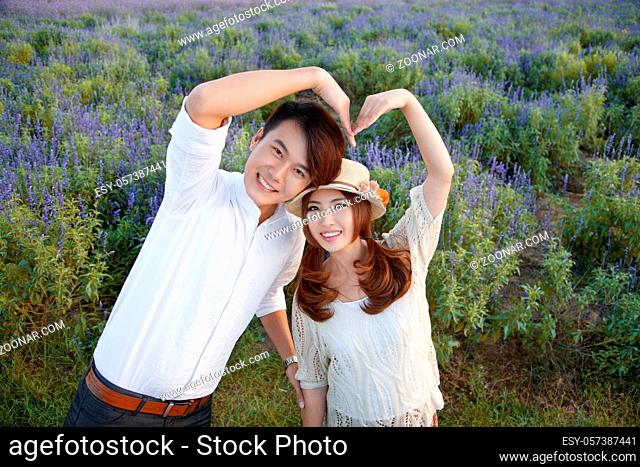Young couple posing heart shape high quality photo