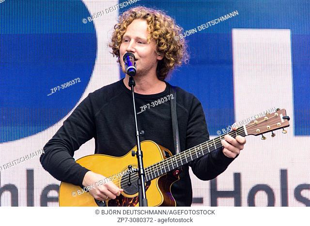 Kiel, Germany - June 24, 2018: Singer-Songwriter and ESC-Participant Michael Schulte is performing on the Hörnbühne during the Kieler Woche 2018