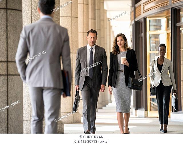 Corporate business people walking in cloister