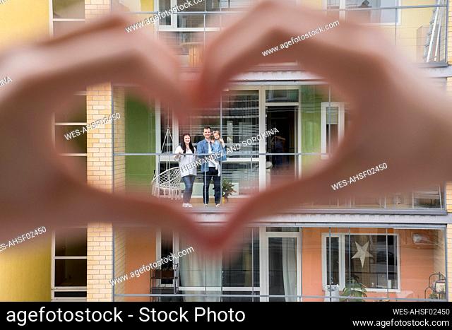 Woman's hands shaping heart with hands for her neighbours