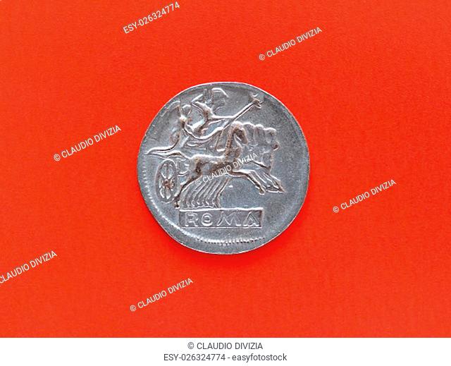 Ancient Roman coin with chariot over red background