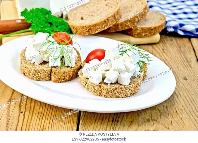 Bread with cheese and tomatoes in white plate