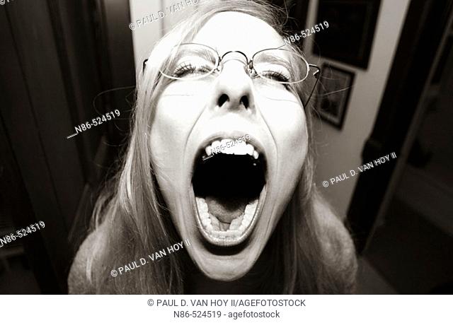 Girl screaming with mouth wide open