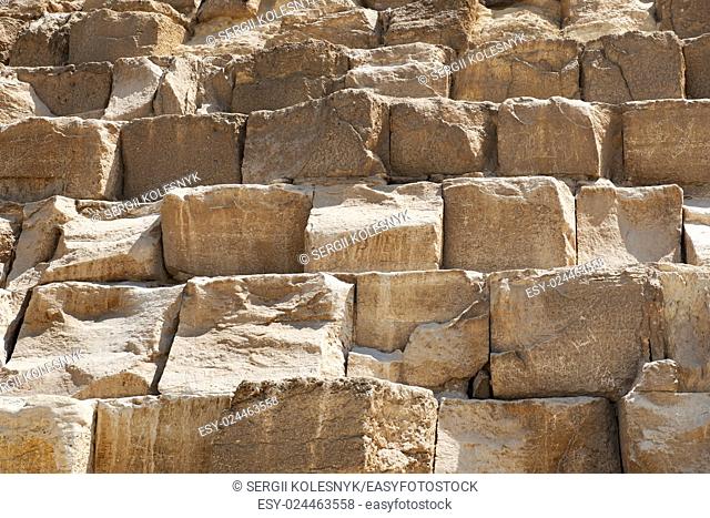 Brown stony wall of egyptian pyramid closeup