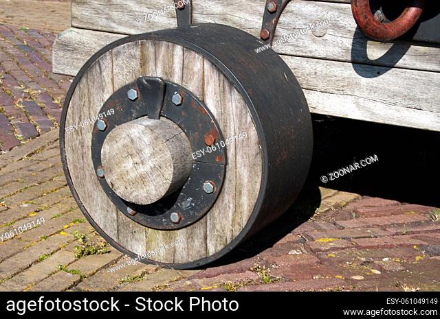 old wooden wheel with metal nails