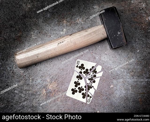 Hammer with a broken card, vintage look, ten of clubs