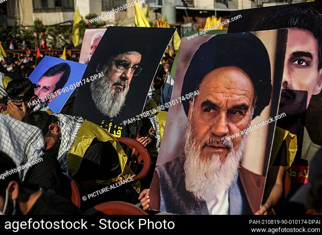 19 August 2021, Lebanon, Beirut: Pictures of later Iranian supreme leader Ayatollah Khomeini and Sayed Hassan Nasrallah, Secretary-General of Shia Islamist...