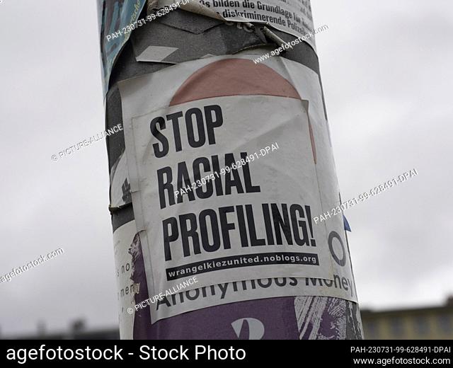 31 July 2023, Berlin: The words ""Stop Racial Profiling!"" can be seen on a lamppost in Görlitzer Park. The green space in Kreuzberg is a frequent source of...
