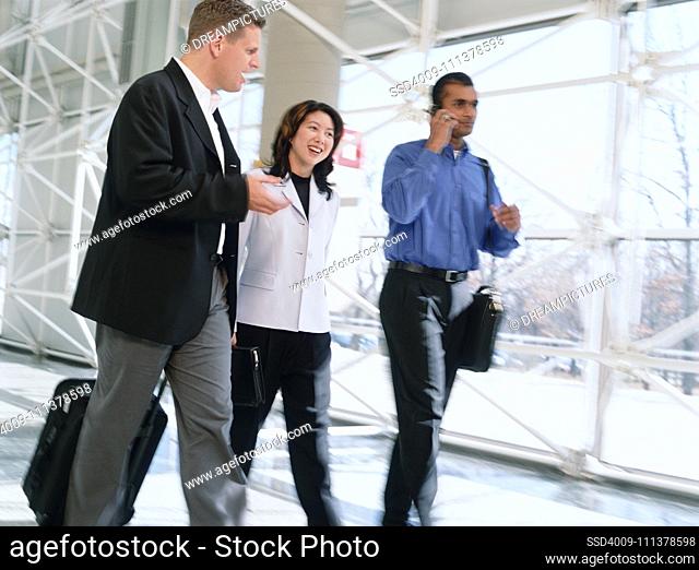 Multi-ethnic businesspeople walking in airport