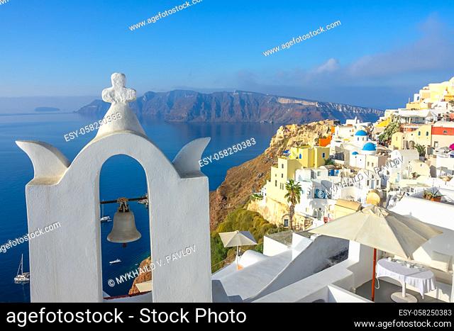 Greece. A sunny day on Santorini. Church bell and hotel terraces in Oia