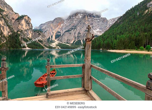 A boat with flower decoration is tethered on the stairway of Lake Braies (Pragser Wildsee, Lago di Braies) boathouse. Fanes-Sennes-Braies Nature Park in the...