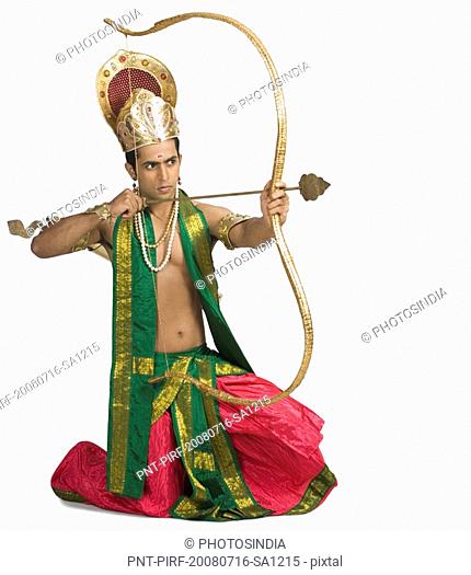 Man dressed-up as a mythological character and holding a bow and an arrow