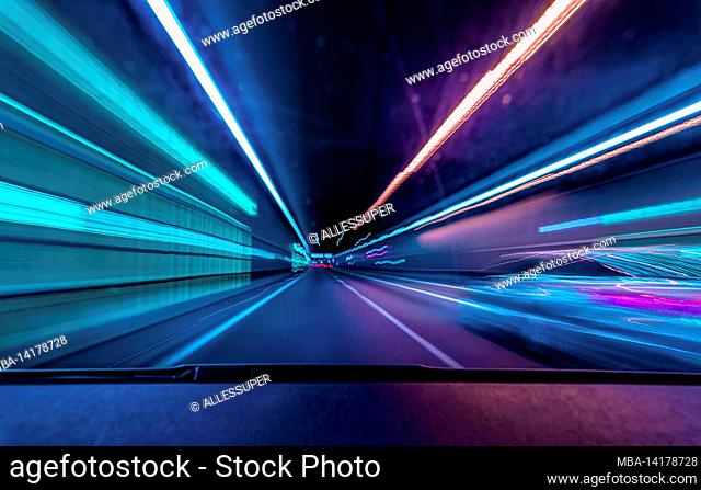 Highspeed underground drive - colorful concept for racing though the night and overtake another car in a tunnel with motion blur effect